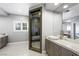 Contemporary bathroom featuring dual vessel sinks, marble countertop, and sleek glass shower enclosure at 2325 Prometheus Ct, Henderson, NV 89074