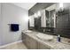 Stylish bathroom with dual vessel sinks, granite countertop, modern lighting, and black tile backsplash at 2325 Prometheus Ct, Henderson, NV 89074