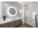Modern bathroom with an oval mirror, stylish vessel sink, sleek vanity, and a frameless glass shower at 2325 Prometheus Ct, Henderson, NV 89074