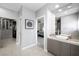 Elegant bathroom with dual sink vanity, tiled floors, and doorway leading to bedroom and walk-in closet at 2325 Prometheus Ct, Henderson, NV 89074