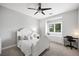 This bedroom features a ceiling fan, a window seat, and desk at 2325 Prometheus Ct, Henderson, NV 89074