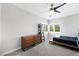Simple bedroom with black modern bed frame and a wooden dresser; bright windows letting in light at 2325 Prometheus Ct, Henderson, NV 89074