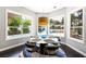 Bright breakfast nook with backyard pool views, with a modern round table and contemporary lighting fixture at 2325 Prometheus Ct, Henderson, NV 89074