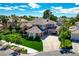 Beautiful two-story home with a well-manicured front yard, mature trees, and a welcoming driveway at 2325 Prometheus Ct, Henderson, NV 89074