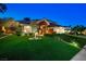 A stately two-story brick home with lush green lawn and mature trees at 2325 Prometheus Ct, Henderson, NV 89074