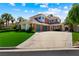 Charming two-story home featuring a three-car garage, lush lawn, and beautiful landscaping at 2325 Prometheus Ct, Henderson, NV 89074