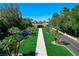 Expansive estate with manicured front lawn, mature trees, and a grand entrance, creating a luxurious curb appeal at 2325 Prometheus Ct, Henderson, NV 89074