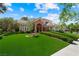 Attractive home with a manicured lawn, arched entry, and mature trees in a desirable neighborhood at 2325 Prometheus Ct, Henderson, NV 89074