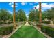 Inviting community greenway with manicured landscaping, trees, and shrubs along paved walkway at 2325 Prometheus Ct, Henderson, NV 89074