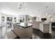 Spacious kitchen with a large island, dark countertops and dark wood floors throughout at 2325 Prometheus Ct, Henderson, NV 89074