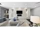 Elegant living room features a textured wall, a modern fireplace, and comfortable furnishings at 2325 Prometheus Ct, Henderson, NV 89074
