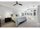 Serene main bedroom featuring large windows, vaulted ceilings, and a ceiling fan at 2325 Prometheus Ct, Henderson, NV 89074