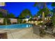 Refreshing pool area with a dining table, lounge chairs, and lush greenery, creating a perfect backyard oasis at 2325 Prometheus Ct, Henderson, NV 89074