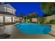 Stunning pool with clear blue water surrounded by patio space, lush landscaping, and comfortable seating at 2325 Prometheus Ct, Henderson, NV 89074
