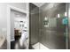 Elegant open bathroom with glass shower featuring dark modern tile and an adjacent seating area visible at 2325 Prometheus Ct, Henderson, NV 89074