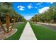 Scenic street view lined with mature palm trees and lush landscaping, enhancing the neighborhood's appeal at 2325 Prometheus Ct, Henderson, NV 89074