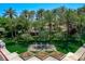 Elevated view of decorative water feature and landscaping, with palm trees and manicured lawns at 2325 Prometheus Ct, Henderson, NV 89074
