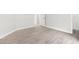 Bright bedroom with a window featuring neutral walls, wood-look tile flooring, and a walk-in closet at 2588 Mizzoni Cir, Henderson, NV 89052