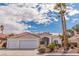 Charming single-story home with a three-car garage, tile roof, and lush landscaping under a bright blue sky at 2588 Mizzoni Cir, Henderson, NV 89052