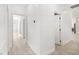Bright hallway featuring neutral walls, wood-look tile flooring, and doorways into various rooms at 2588 Mizzoni Cir, Henderson, NV 89052