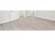 Bright hallway featuring neutral walls, wood-look tile flooring, and doorways into various rooms at 2588 Mizzoni Cir, Henderson, NV 89052