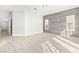 Spacious living area with wood-look floors and a stylish accent wall, creating a welcoming ambiance at 2588 Mizzoni Cir, Henderson, NV 89052