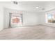 Bright, open living room with hardwood flooring, large windows and neutral paint, creating an airy atmosphere at 2588 Mizzoni Cir, Henderson, NV 89052