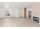 Open living space with neutral decor, modern fireplace, and light wood floors creating a spacious atmosphere at 2588 Mizzoni Cir, Henderson, NV 89052