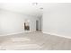 Open-concept living room boasts bright, neutral walls and floors, with an open doorway to the kitchen at 2588 Mizzoni Cir, Henderson, NV 89052