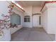 Inviting front entry featuring a covered porch with white stucco walls, tiled floor and decorative windows at 2588 Mizzoni Cir, Henderson, NV 89052
