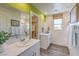 Bright bathroom features dual sinks, framed mirrors, modern fixtures, a window, and a walk-in closet at 2641 Begonia Falls Ave # 88, North Las Vegas, NV 89081