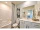 Neat bathroom boasts a tub and shower combo, decorative wall art, and a modern vanity at 2641 Begonia Falls Ave # 88, North Las Vegas, NV 89081