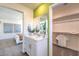 Bathroom with single sink vanity, mirror and view into bedroom and walk-in closet at 2641 Begonia Falls Ave # 88, North Las Vegas, NV 89081