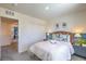 Bright bedroom features a queen bed, fresh white linens, and a decorative blue accent wall at 2641 Begonia Falls Ave # 88, North Las Vegas, NV 89081