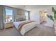 Primary bedroom with a large bed, and great natural light with an ensuite bathroom at 2641 Begonia Falls Ave # 88, North Las Vegas, NV 89081