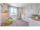 Cozy Bedroom with soft colors, a comfortable chair, and a crib, creating a welcoming atmosphere at 2641 Begonia Falls Ave # 88, North Las Vegas, NV 89081