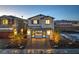Exterior of home with a welcoming entryway, lush landscaping, and modern architectural details at 2641 Begonia Falls Ave # 88, North Las Vegas, NV 89081