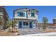 Charming two-story home with a well-maintained lawn and stylish blue accents on windows and doors at 2641 Begonia Falls Ave # 88, North Las Vegas, NV 89081
