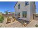 Rear exterior view showcases the patio seating and low maintenance desert landscaping at 2641 Begonia Falls Ave # 88, North Las Vegas, NV 89081