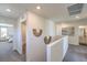 Upstairs hallway with decorative wall hangings leads to bedrooms and bathrooms at 2641 Begonia Falls Ave # 88, North Las Vegas, NV 89081