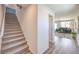Inviting hallway with stylish hardwood floors and staircase leading to the upper level of the home at 2641 Begonia Falls Ave # 88, North Las Vegas, NV 89081