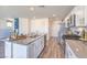 Modern kitchen with white cabinetry, granite countertops, stainless steel appliances, and an island at 2641 Begonia Falls Ave # 88, North Las Vegas, NV 89081