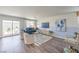 Comfortable living room with modern furnishings, a large TV, and access to the outdoor patio at 2641 Begonia Falls Ave # 88, North Las Vegas, NV 89081