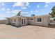 Exterior view of the home showcasing its backyard with white exterior and various windows for ample natural light at 2712 Holmes St, North Las Vegas, NV 89030