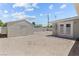 A backyard view of the exterior with a shed, enclosed by a block wall, enhanced by desert landscaping at 2712 Holmes St, North Las Vegas, NV 89030