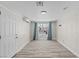 Bright bedroom featuring a window, neutral walls, and sleek laminate flooring at 2712 Holmes St, North Las Vegas, NV 89030