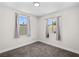 This bedroom offers neutral walls and carpeted floors with natural light coming in from the windows at 2712 Holmes St, North Las Vegas, NV 89030