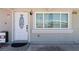Close-up of the front door with a decorative window and a view reflecting in the window next to it at 2712 Holmes St, North Las Vegas, NV 89030