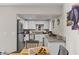 Well-lit kitchen with white cabinets, granite countertops and stainless steel appliances, open to dining area at 2712 Holmes St, North Las Vegas, NV 89030