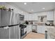 Modern kitchen with stainless steel appliances, white cabinets and plenty of counter space at 2712 Holmes St, North Las Vegas, NV 89030